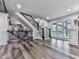 Spacious living room features hardwood floors, staircase, and bright windows at 5039 Towne Lake Hills North, Woodstock, GA 30189