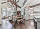 Spacious open-concept living space featuring exposed beams, stone fireplace, and eat-in kitchen with stainless appliances at 5039 Towne Lake Hills North, Woodstock, GA 30189