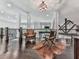 Open loft area featuring hardwood floors, ample natural light, and comfortable seating with desk setup at 5039 Towne Lake Hills North, Woodstock, GA 30189