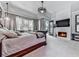 Spacious main bedroom with a fireplace, tray ceiling, and natural light at 5039 Towne Lake Hills North, Woodstock, GA 30189