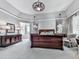 Bright main bedroom featuring tray ceilings, dark wood furniture, and plush carpet at 5039 Towne Lake Hills North, Woodstock, GA 30189