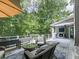 Outdoor living area features wood deck, seating, and wooded view at 5039 Towne Lake Hills North, Woodstock, GA 30189