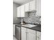 Charming kitchen counter featuring decorative tiling and white cabinets at 520 Park Se Ave # 2, Atlanta, GA 30312
