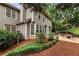 Backyard features seating, lush greenery, and privacy fence with a traditional style house in the background at 5860 Fairway View Dr, Suwanee, GA 30024