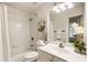 Bright bathroom featuring a shower and tub combo with a white shower curtain and a single sink vanity at 5860 Fairway View Dr, Suwanee, GA 30024
