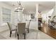 Charming dining area with natural light and a view of the living room and stone fireplace at 5860 Fairway View Dr, Suwanee, GA 30024
