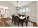 Well-lit dining room with hardwood floors, modern chandelier, and a view of the home's entry at 5860 Fairway View Dr, Suwanee, GA 30024