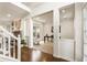 Open foyer showcasing hardwood floors, stairs, and bright adjacent living room with fireplace and windows at 5860 Fairway View Dr, Suwanee, GA 30024