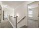 Upstairs hallway with neutral carpet and white trim and a view of the bedrooms at 5860 Fairway View Dr, Suwanee, GA 30024