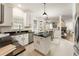 Bright kitchen with granite countertops and eat-in dining area with views into the living room at 5860 Fairway View Dr, Suwanee, GA 30024