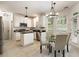 White kitchen with stainless steel appliances, granite countertops, and an eat-in dining area at 5860 Fairway View Dr, Suwanee, GA 30024