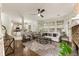 Bright living room featuring hardwood floors, a stone fireplace, and large windows that provide ample natural light at 5860 Fairway View Dr, Suwanee, GA 30024