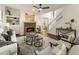 Cozy living room with a stone fireplace, neutral color palette, and view of the stairway at 5860 Fairway View Dr, Suwanee, GA 30024