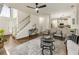 Open-concept living room with hardwood floors leading to the kitchen and staircase at 5860 Fairway View Dr, Suwanee, GA 30024