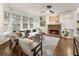 Bright living room featuring a stone fireplace, hardwood floors, and large windows at 5860 Fairway View Dr, Suwanee, GA 30024