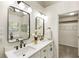 Bright bathroom featuring double sinks, modern fixtures, and lots of natural light with a view to the walk-in closet at 5860 Fairway View Dr, Suwanee, GA 30024