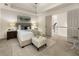 Bright main bedroom featuring tray ceilings, neutral color palette, with an adjacent sitting room at 5860 Fairway View Dr, Suwanee, GA 30024