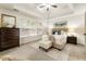 Comfortable main bedroom showcasing plush carpet, ceiling fan, and natural light from the windows at 5860 Fairway View Dr, Suwanee, GA 30024