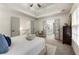 Tranquil main bedroom with tray ceilings, neutral decor and access to ensuite bathroom at 5860 Fairway View Dr, Suwanee, GA 30024