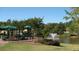Scenic community playground near a pond with a fountain, surrounded by lush trees, creating a fun recreational space at 5860 Fairway View Dr, Suwanee, GA 30024