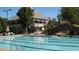 Resort-style pool with lap lanes next to a building with a decorative balcony and arched bridge at 5860 Fairway View Dr, Suwanee, GA 30024