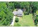 An aerial view of the property and its surroundings with the pool and mature trees at 125 Foxridge Rd, Atlanta, GA 30327