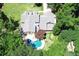An aerial view of the backyard featuring the pool, outdoor kitchen, fireplace, and landscaping at 125 Foxridge Rd, Atlanta, GA 30327