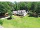 Aerial view of a beautiful home with a manicured lawn, lush landscaping, and a charming facade at 125 Foxridge Rd, Atlanta, GA 30327