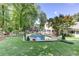 Expansive backyard with a pool, outdoor seating areas, and meticulous landscaping, perfect for relaxation at 125 Foxridge Rd, Atlanta, GA 30327