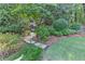 Beautifully landscaped backyard with stone pathway leading to a playhouse and lush plantings at 125 Foxridge Rd, Atlanta, GA 30327