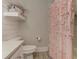 Comfortable bathroom featuring shiplap walls and a decorative pink shower curtain at 125 Foxridge Rd, Atlanta, GA 30327