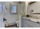 Stylish pool house bathroom with elegant gray vanity, a sink and a window at 125 Foxridge Rd, Atlanta, GA 30327