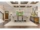 Elegant dining room featuring a coffered ceiling, modern chandelier, and a large window at 125 Foxridge Rd, Atlanta, GA 30327