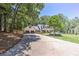 Beautiful two-story home with an attached garage, green lawn and long driveway at 125 Foxridge Rd, Atlanta, GA 30327