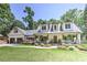 Inviting two-story home with a welcoming porch, dormer windows, and lush landscaping at 125 Foxridge Rd, Atlanta, GA 30327