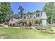 Lovely two-story home with an attached two-car garage, well-kept lawn, and shrubbery at 125 Foxridge Rd, Atlanta, GA 30327