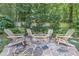 Stone fire pit with Adirondack chairs, set on a stone patio, perfect for outdoor gatherings at 125 Foxridge Rd, Atlanta, GA 30327