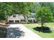 Charming home featuring a manicured front yard, two-car garage and appealing architectural details at 125 Foxridge Rd, Atlanta, GA 30327