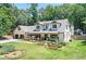 Charming two-story home with manicured landscaping, a covered porch, and a three-car garage at 125 Foxridge Rd, Atlanta, GA 30327