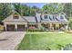 Attractive two-story home with an attached garage and meticulously maintained lawn at 125 Foxridge Rd, Atlanta, GA 30327