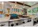 Gourmet kitchen with stainless steel range and island, featuring hanging pendant lights at 125 Foxridge Rd, Atlanta, GA 30327