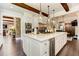 Open-concept kitchen featuring a large island, stainless steel appliances, and brick accents at 125 Foxridge Rd, Atlanta, GA 30327