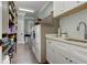 Functional laundry room with modern appliances, custom cabinets, and sink at 125 Foxridge Rd, Atlanta, GA 30327