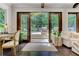 Bright living room with hardwood floors and view of the outdoor pool and patio area at 125 Foxridge Rd, Atlanta, GA 30327