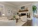 Warm living room features a stone fireplace, an open layout and hardwood floors at 125 Foxridge Rd, Atlanta, GA 30327