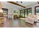Living room with hardwood floors, beamed ceilings, and views into the kitchen and backyard at 125 Foxridge Rd, Atlanta, GA 30327