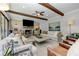 Elegant living room featuring a fireplace, wood beams, and large windows with natural light at 125 Foxridge Rd, Atlanta, GA 30327