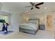 Comfortable main bedroom features a bed with bedside tables and an exercise bike at 125 Foxridge Rd, Atlanta, GA 30327