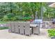 Spacious outdoor dining area with a large table, comfortable seating, and a built-in barbecue grill at 125 Foxridge Rd, Atlanta, GA 30327