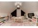 Attic playroom featuring shiplap walls, a unique ceiling light, and a fun tile floor at 125 Foxridge Rd, Atlanta, GA 30327